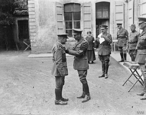 Image © IWM (Q 11128) –  King George V presents the VC to the Reverend T B Hardy, Army Chaplain, at Third Army HQ at Frohen-le-Grand, 9 August 1918. 